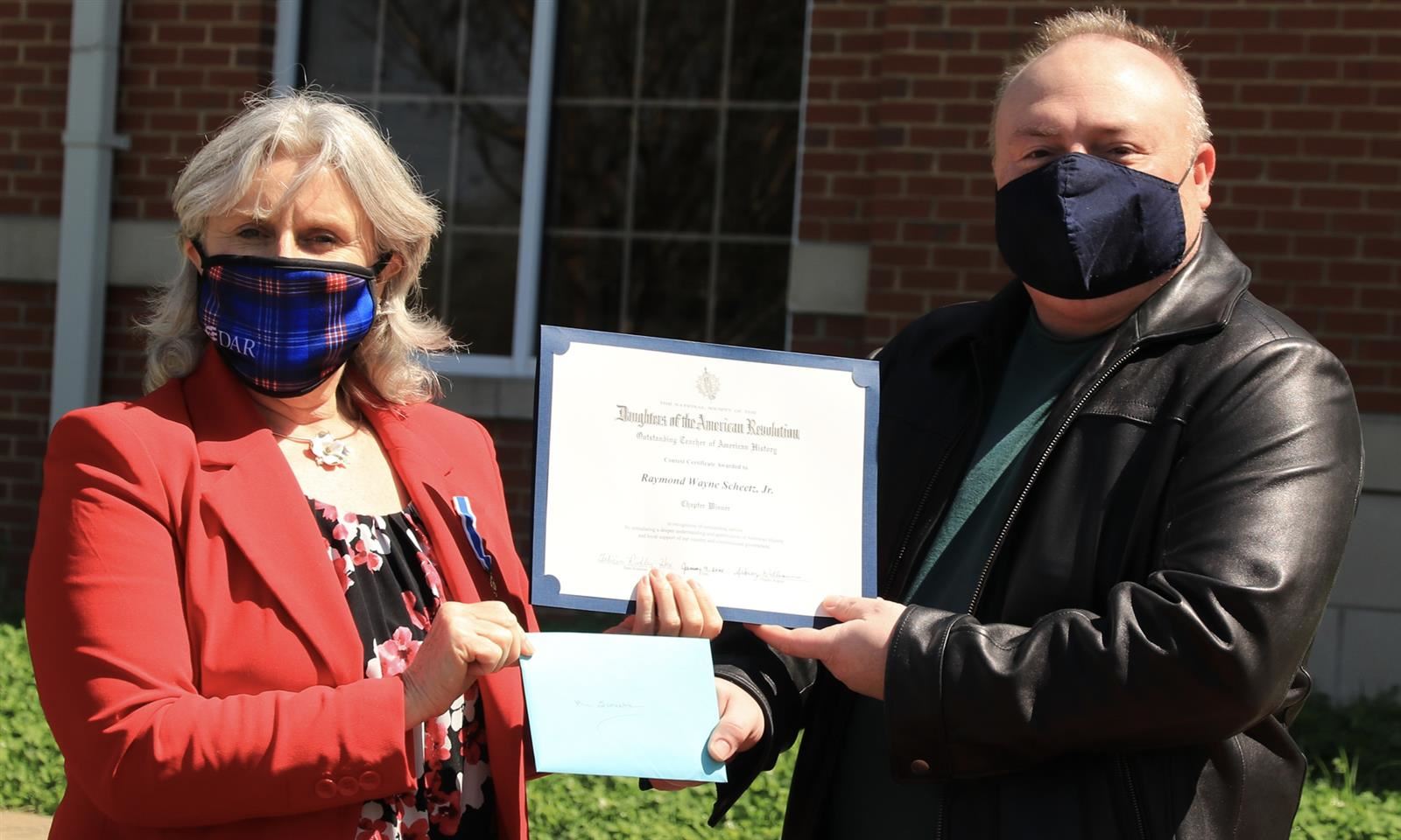 Ray Scheetz receives a certificate and envelope